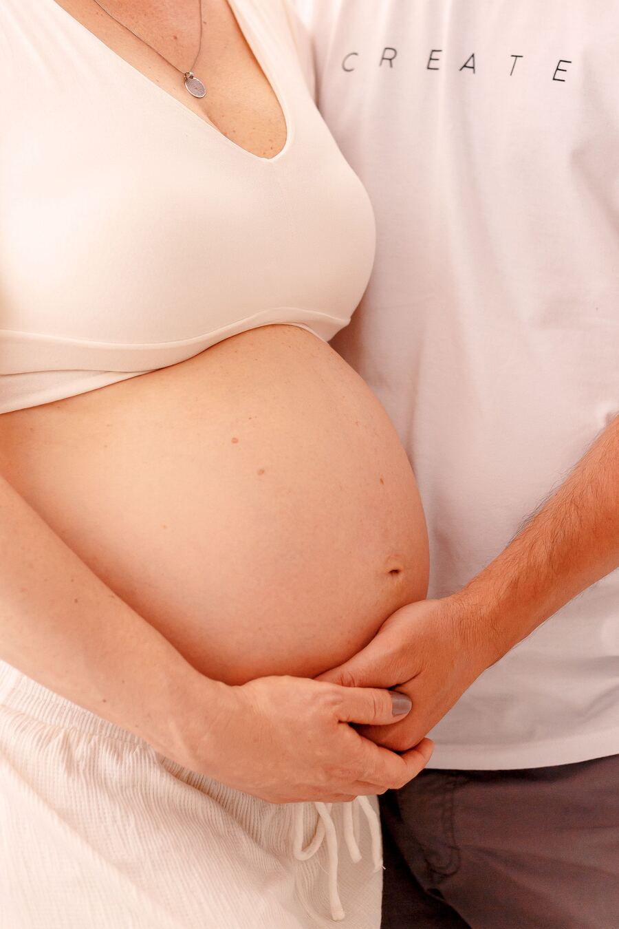 Expecting mother holding her belly after fertility acupuncture and IVF support in Morristown NJ