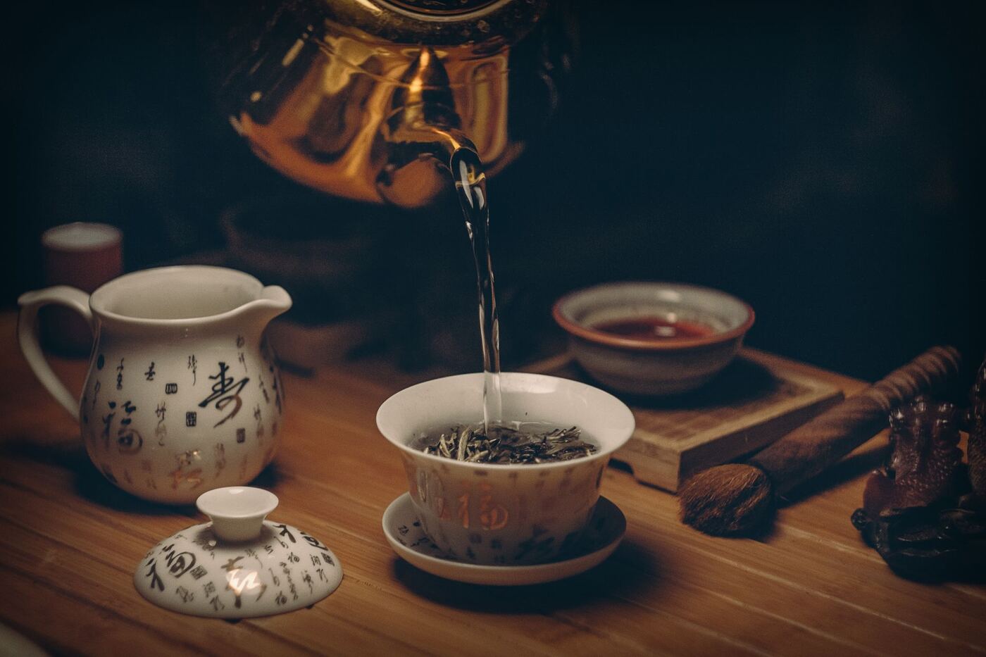Hot water poured over loose tea in a porcelain cup for a calming herbal infusion