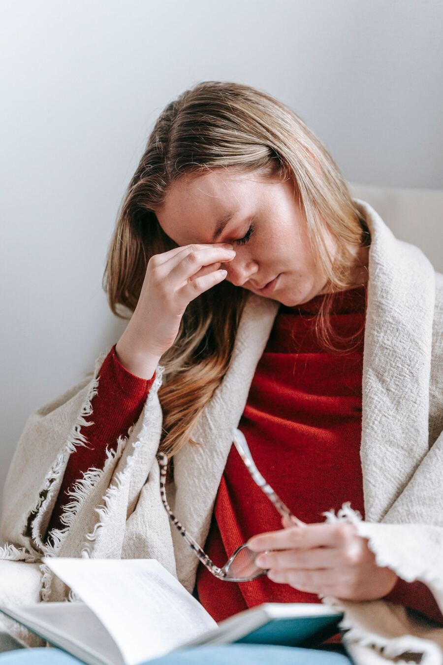 Woman pressing her temple during a migraine headache before acupuncture treatment